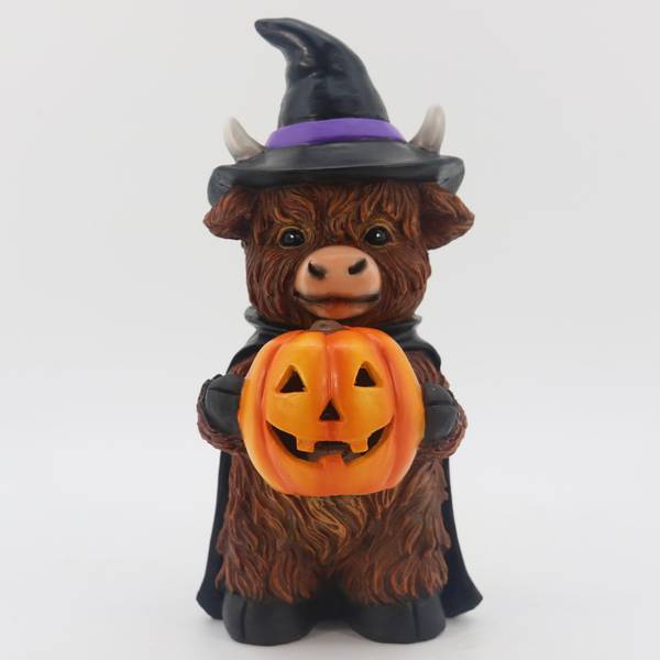 Photo of 10" Polyresin Highland Cow with Pumpkin Witch Tabletop Decor